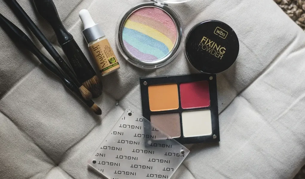 Close-up of makeup products including brushes, foundation, and a fixing powder, emphasizing makeup tips and tricks. Makeup Tips and Tricks by yesvsno.