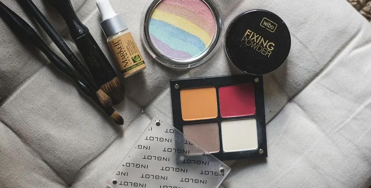 Close-up of makeup products including brushes, foundation, and a fixing powder, emphasizing makeup tips and tricks. Makeup Tips and Tricks by yesvsno.