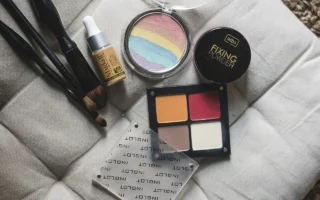 Close-up of makeup products including brushes, foundation, and a fixing powder, emphasizing makeup tips and tricks. Makeup Tips and Tricks by yesvsno.