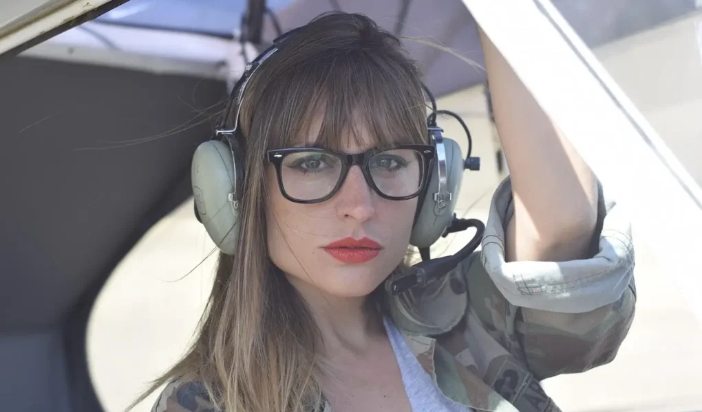 Woman with aviator-style eyeglasses, perfect for aviation enthusiasts, showcasing Perfect Eyeglasses on yesvsno.net.