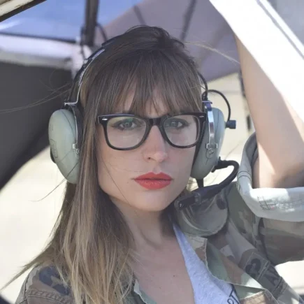 Woman with aviator-style eyeglasses, perfect for aviation enthusiasts, showcasing Perfect Eyeglasses on yesvsno.net.