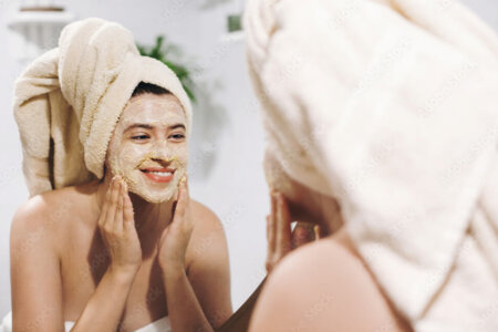 women-applying-face-mask-checking-in-mirror