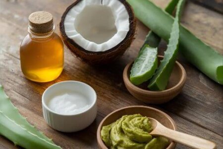 Natural skincare ingredients like aloe vera, coconut oil, and yogurt placed on a wooden table for a DIY skincare routine.