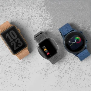 3 smart watches a peach one gray one and blue one placed on a gray concrete background