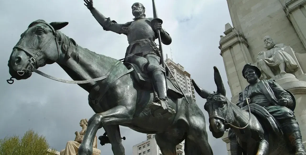 A grand statue of Don Quixote on horseback, illustrating his commitment to honor and ideals in Don Quixote Sayings, showcasing the conflict of yes vs no between belief and reality.