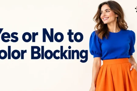 a person wearing a bold two-color color-blocked outfit, like a bright blue top with an orange skirt, standing against a plain light background, soft natural light, bright and modern photography style.